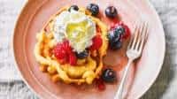 American-style funnel cake with glazed mixed berries & cream