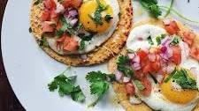 Breakfast Tacos With Sunny Side Up Eggs, Fresh Tomatoes, Red Onion, Cilantro And Green Sriracha Sauce