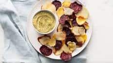 Oven-baked vegetable chips with creamy pesto hummus