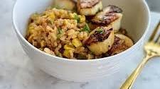 Scallops over bacon and corn risotto