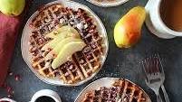 Spiced Pear Waffles Topped With Pomegranates, Hazelnuts And Maple Syrup