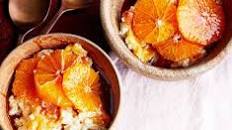 Baked cardamom-scented rice pudding with oranges in honey & pomegranate syrup