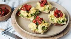 Scrambled eggs on avocado toast with salsa
