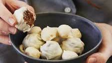 White chocolate covered macadamia bliss balls and whole macadamias