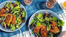Zucchini-chickpea köfte over mixed greens with mango dressing