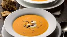 Pumpkin, saffron and orange soup with caramelised pumpkin seeds