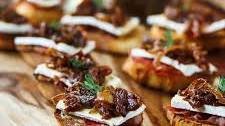 Crostini with Onion & Fig Jam, Roasted Garlic, Brie & Prosciutto